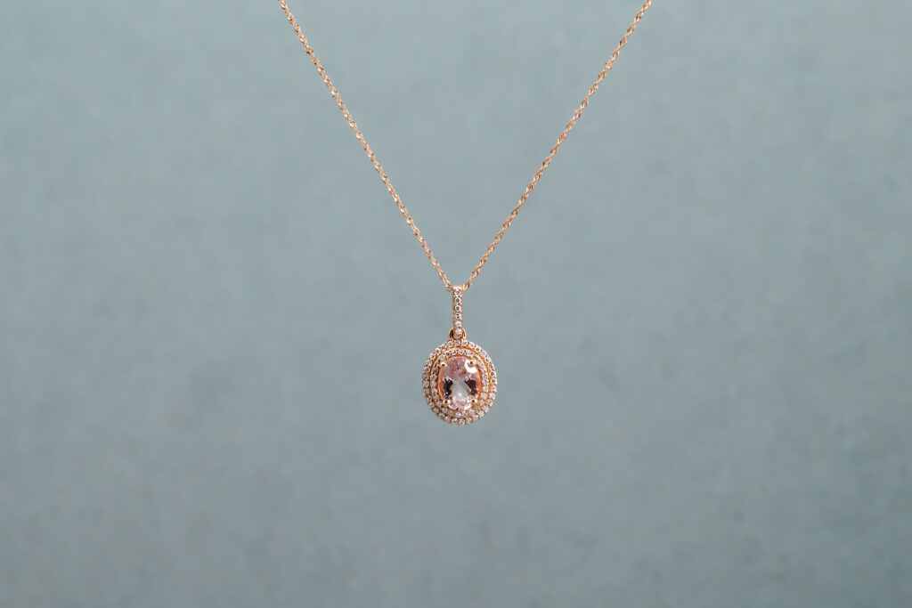 Gold necklace with a pink pendant 
