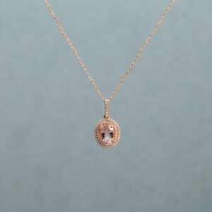 Gold necklace with a pink pendant 