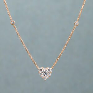 A Gold and White necklace with a heart-shaped pendant 