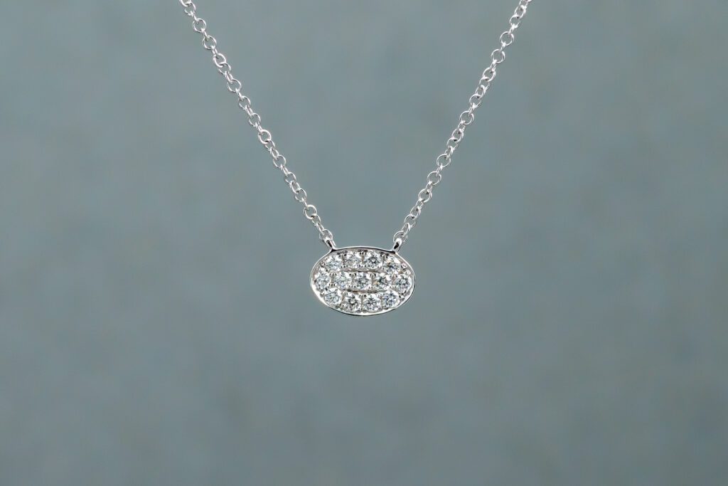 A Silver necklace with an oval-shaped pendant 