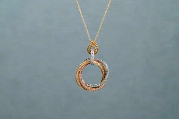 A White Gold necklace with various interlocked rings connected to a tear-shaped pendant