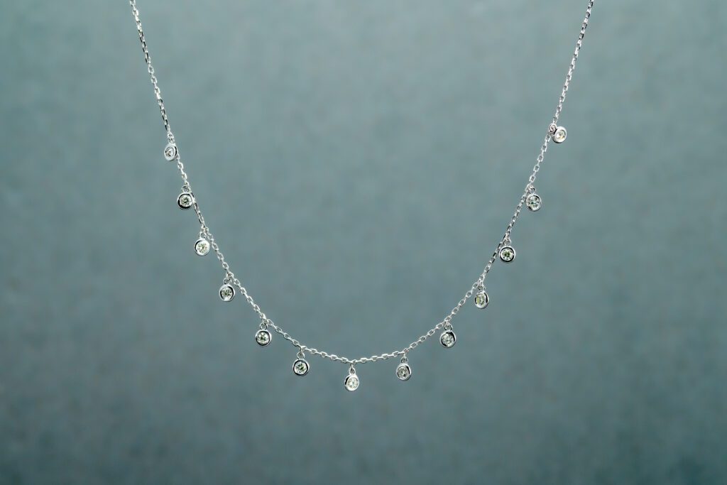 A Silver necklace with 13 small-sized pendants