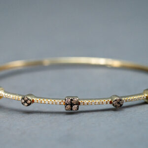 A Gold bracelet with some Pink pendants 