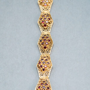 A long chain with different colored stones on it.