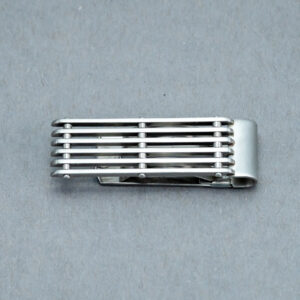 A silver tie clip with a metal strip across the top of it.