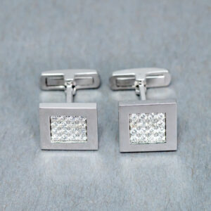 A pair of cufflinks with a square design.