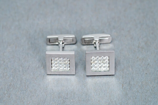 A pair of cufflinks with a square design.