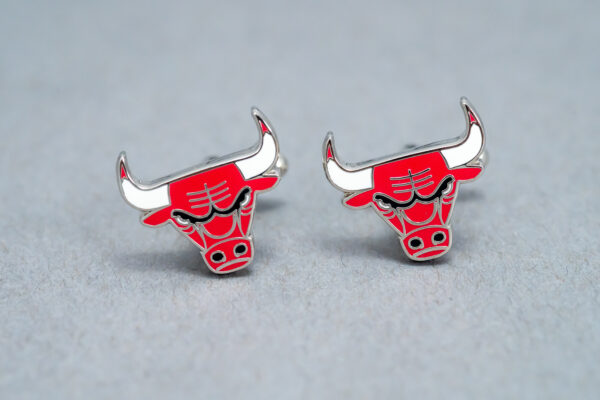 A pair of bulls earrings on top of a table.