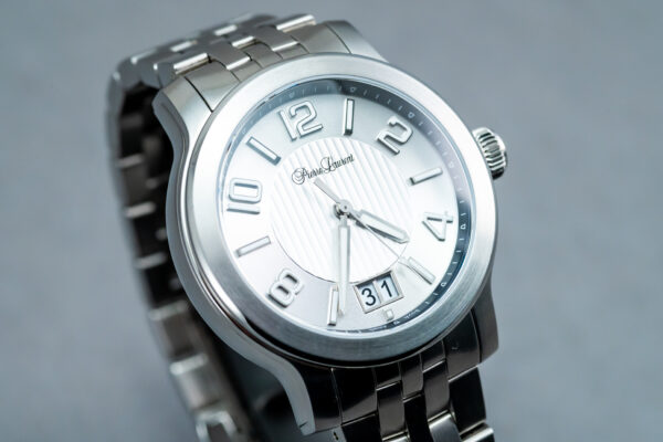A silver watch with roman numerals on it.