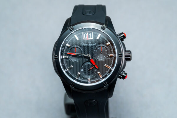A black watch with red and white numbers on it.