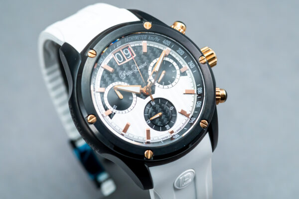 A white and black watch with gold accents.