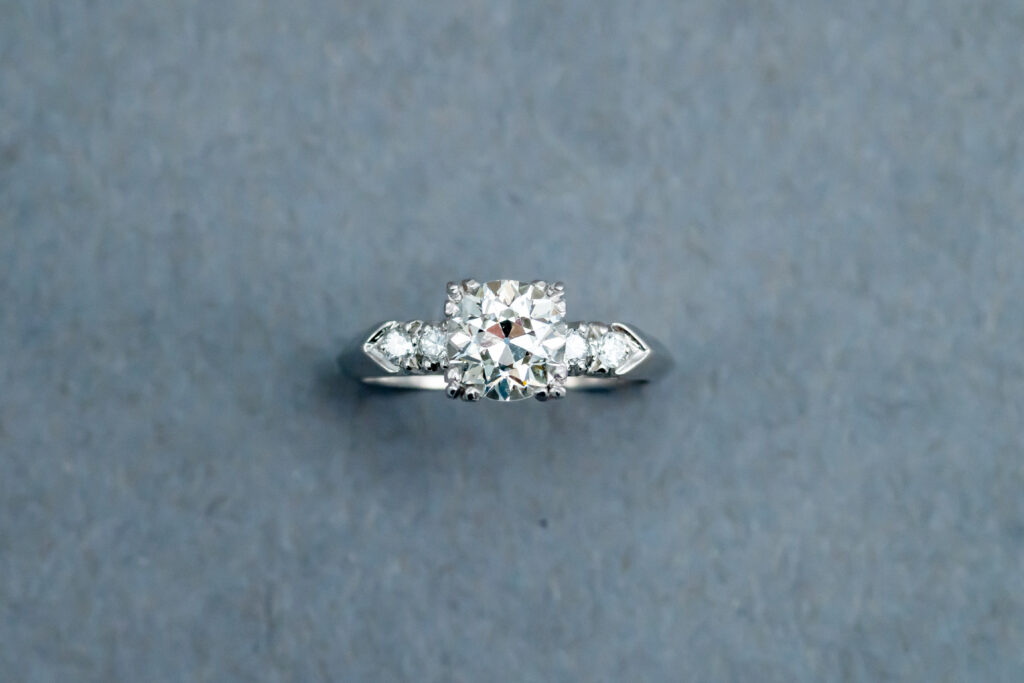 A diamond ring with six small diamonds on it.