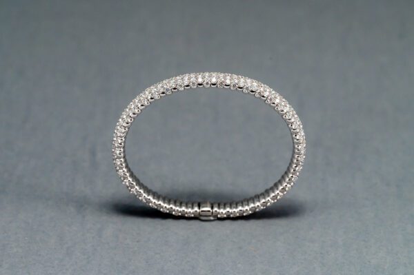 A close up of a silver ring on a gray background