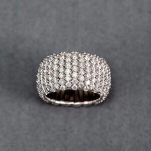 A silver ring with many rows of diamonds.