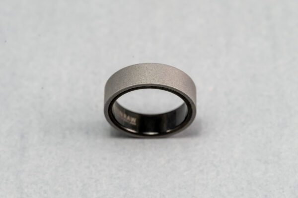 A close up of a ring on top of a white surface
