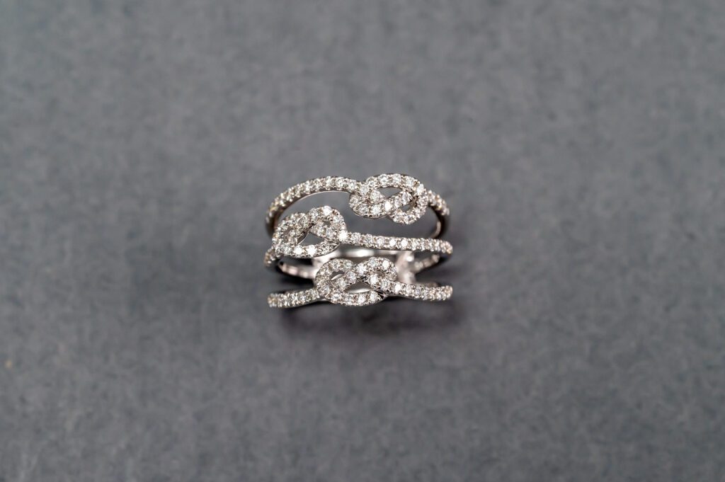 A silver ring with some diamonds on it