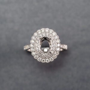 A diamond ring with an oval cut center stone.