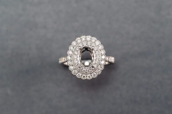 A diamond ring with an oval cut center stone.