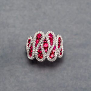 A silver ring with red stones on it.