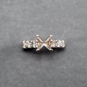 A diamond ring with a square cut stone on it.