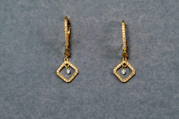 A pair of gold earrings with diamond shaped dangling from the bottom.