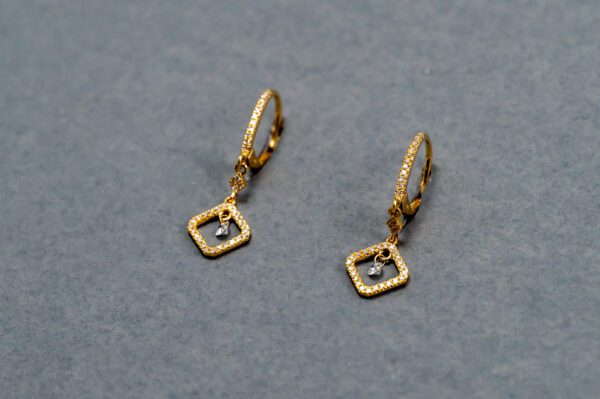 A pair of gold earrings with diamond accents.