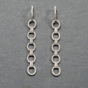 A pair of silver earrings with a long chain.