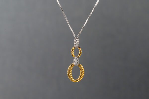 A necklace with two gold and diamond rings on it.