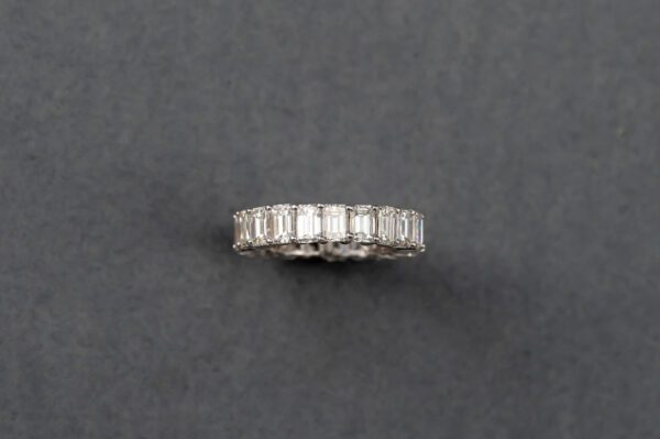 A silver ring with some white stones on it