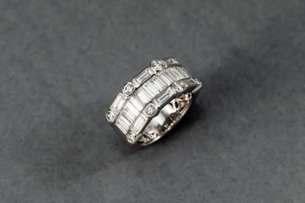 A silver ring with some white stones on it