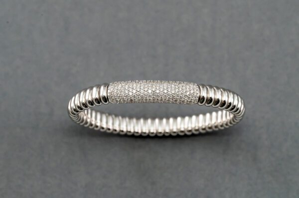 A silver bracelet with some white stones on it