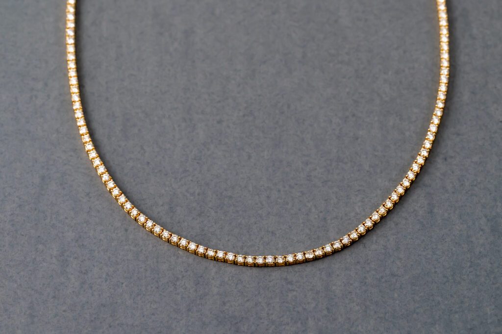 A close up of a necklace on a gray surface