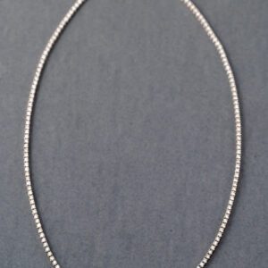 A silver chain with a diamond necklace on it.