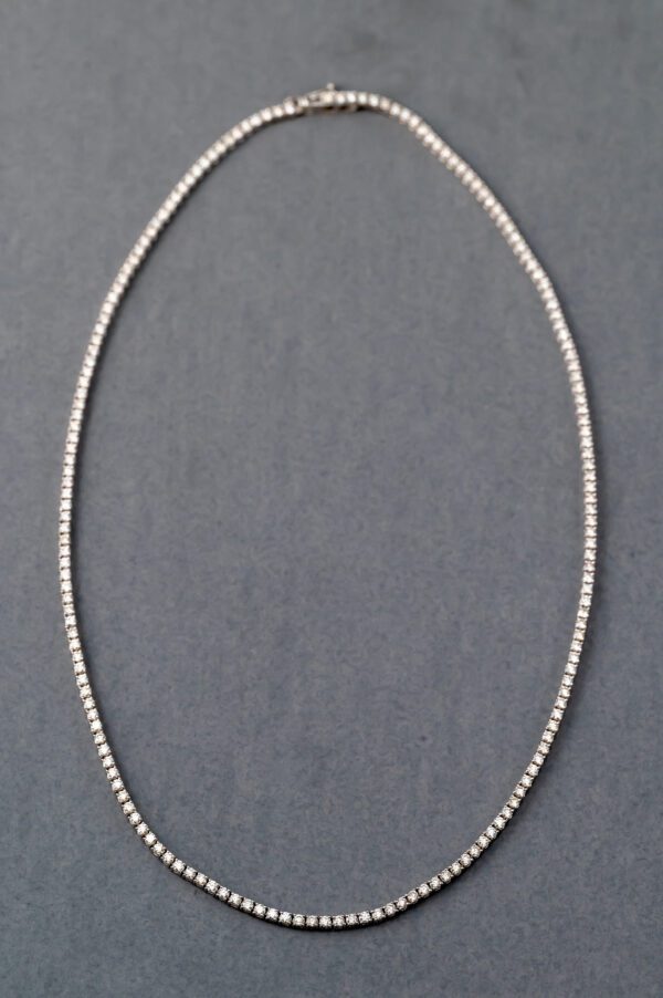 A silver chain with a diamond necklace on it.