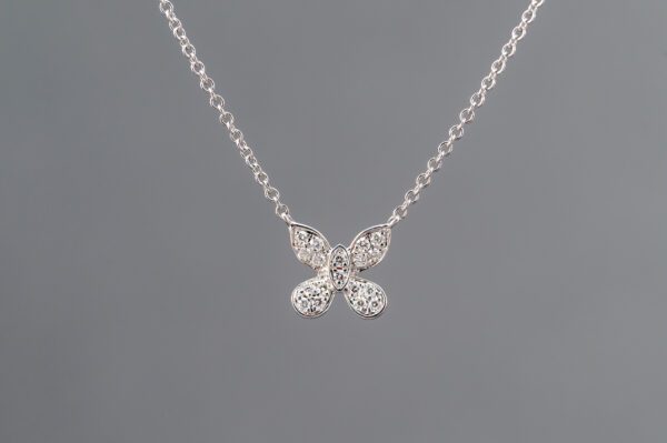 A silver necklace with four small diamonds on it.