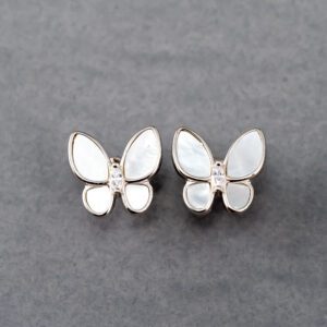 A pair of butterfly earrings with mother of pearl and diamond.