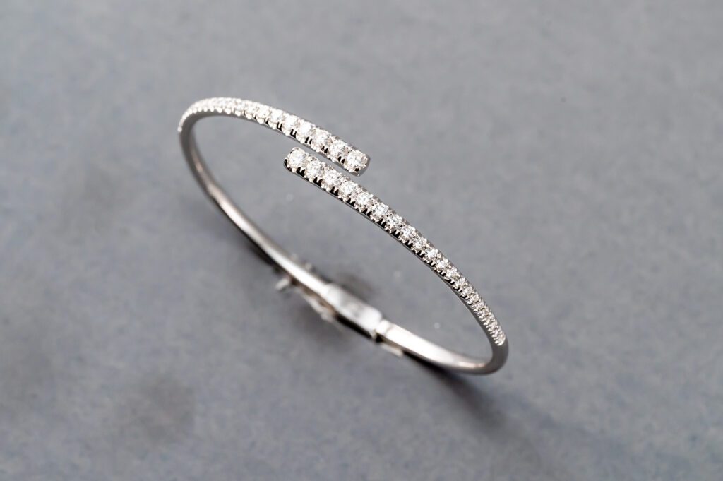 A silver bracelet with some diamonds on it