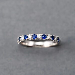 A silver ring with blue and white stones.