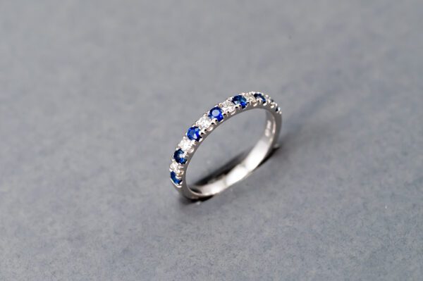 A silver ring with blue stones on top of it.