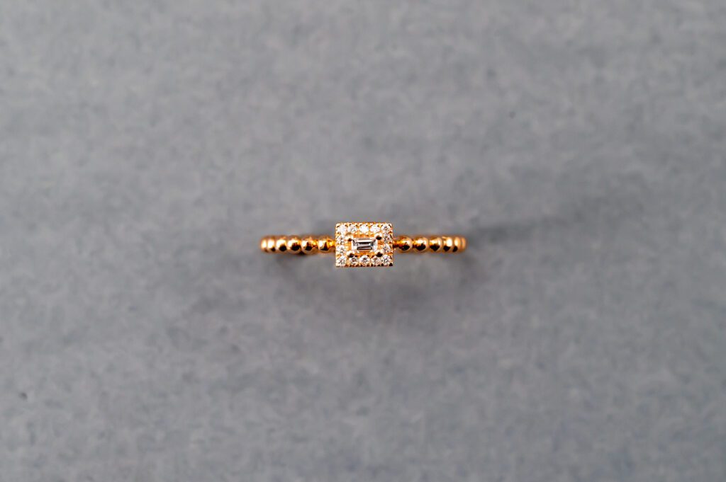 A gold ring with a diamond on it