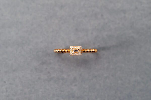 A gold ring with a diamond on it