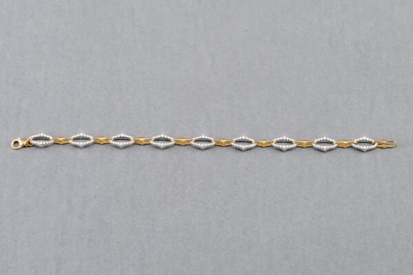 A chain of gold and silver links on a gray background.