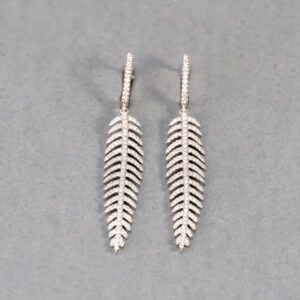 A pair of silver earrings with a leaf design.
