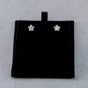 A black earring box with some small earrings