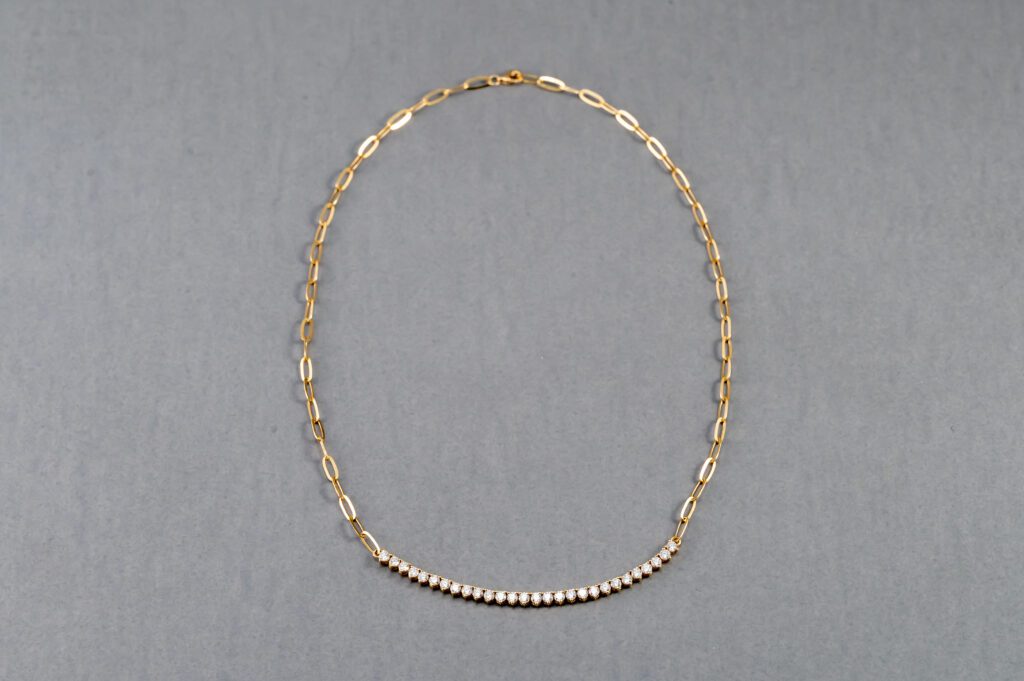 A necklace with a row of pearls on it.