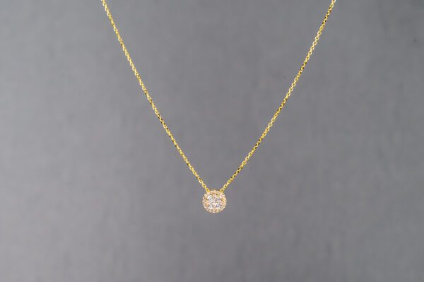 A gold necklace with a small diamond on it.