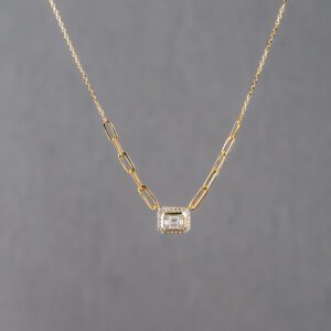 A gold chain with a diamond on it