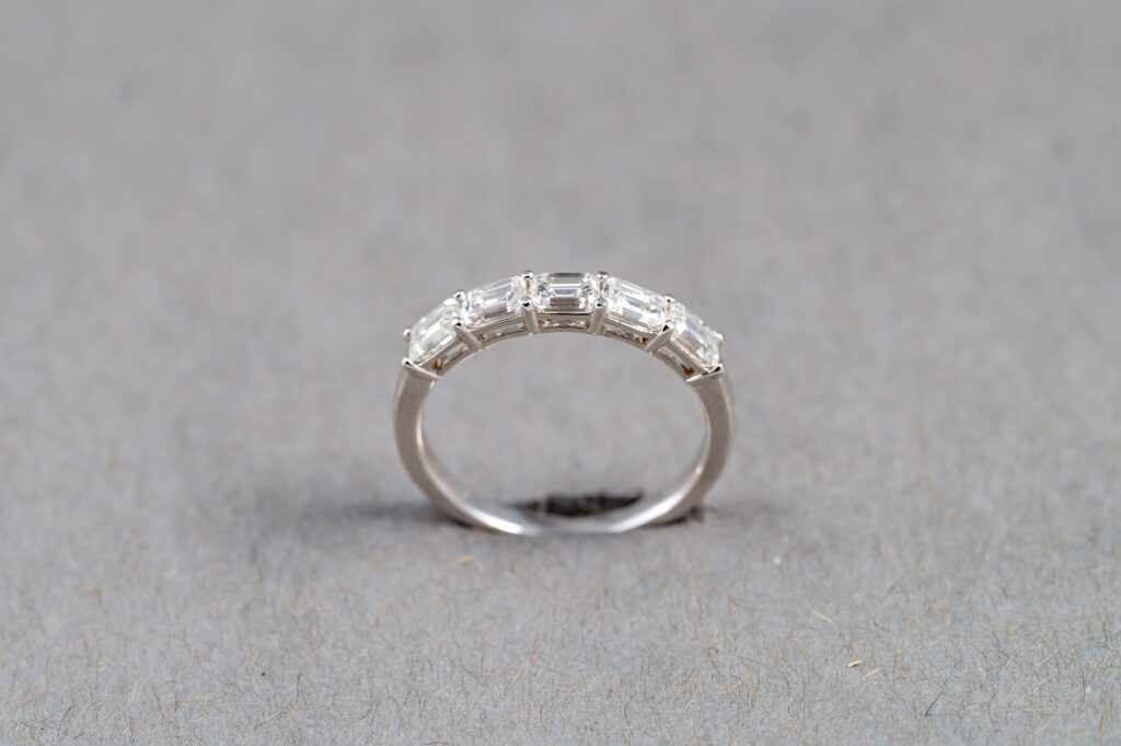 A silver ring with some kind of diamond on it