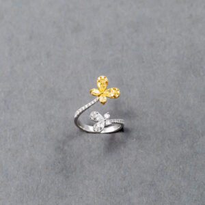 A silver ring with a yellow flower on it.